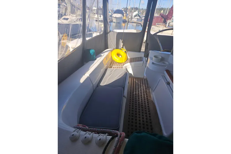 Slide: The Image of Interior view of a 1998 Beneteau 381 sailboat cockpit with seating and nautical equipment. - 49