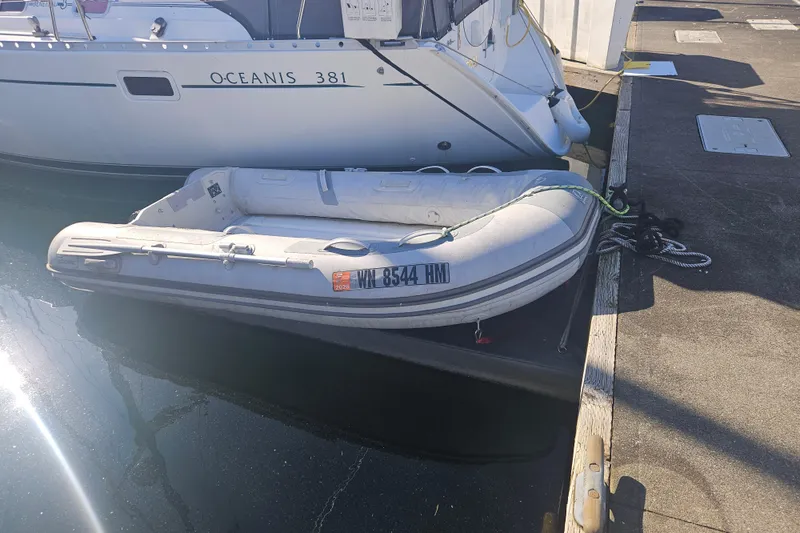 Slide: The Image of Beneteau Oceanis 381 sailboat docked with inflatable dinghy, 1998 model. - 5