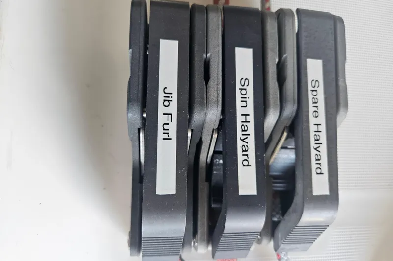 Slide: The Image of Close-up of labeled rope clutches on a 1998 Beneteau 381 sailboat. - 54