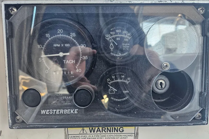 Slide: The Image of Control panel of a 1998 Beneteau 381 sailboat with Westerbeke tachometer and gauges. - 59