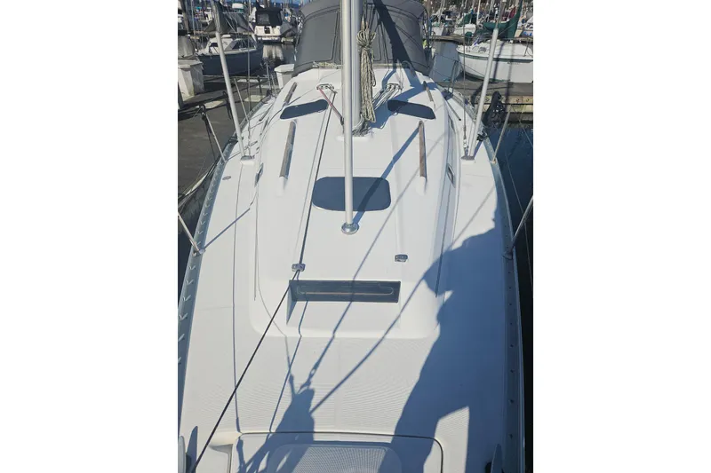 Slide: The Image of 1998 Beneteau 381 sailboat deck view at marina, showcasing sleek design and rigging. - 15