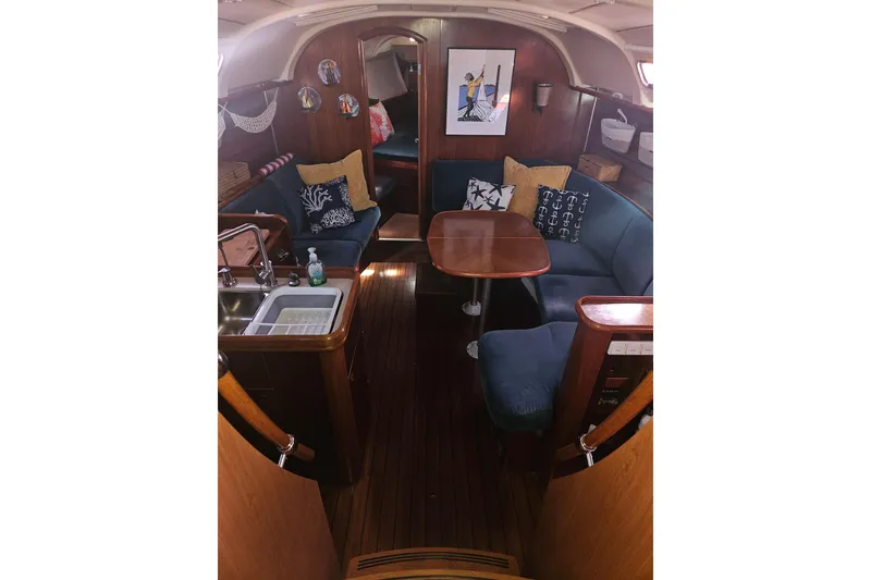 Slide: The Image of Interior of a 1998 Beneteau 381 sailboat with cozy seating and wooden finishes. - 18