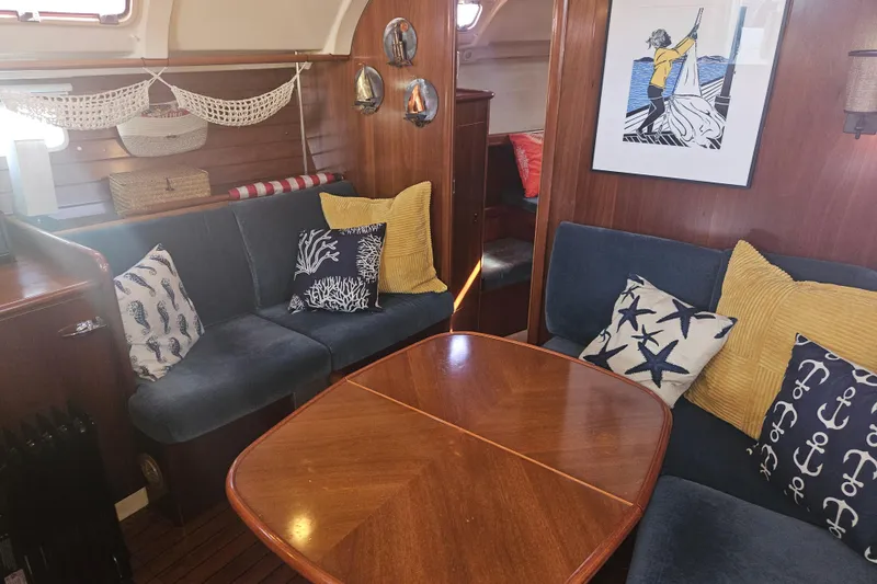 Slide: The Image of Cozy interior of 1998 Beneteau 381 sailboat with nautical-themed decor and wooden furnishings. - 22