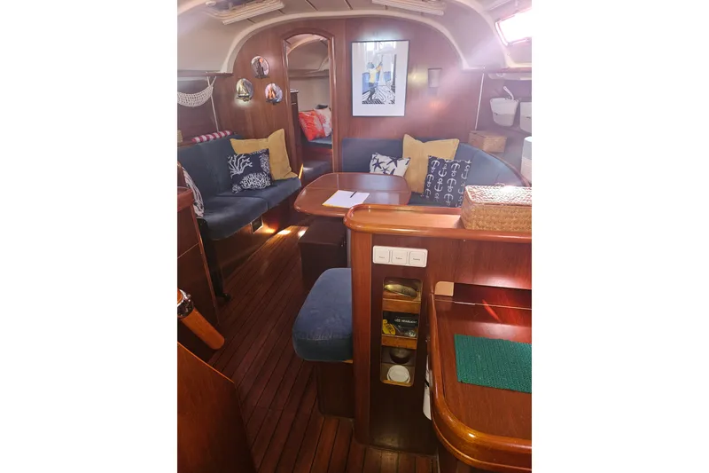 Slide: The Image of Interior of 1998 Beneteau 381 sailboat with wooden cabinetry and compact kitchen appliances. - 32