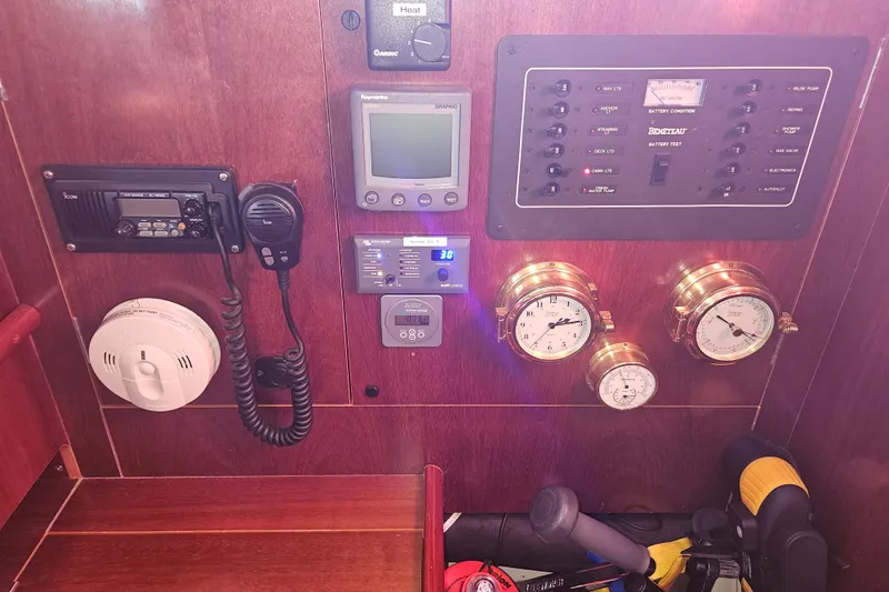 Slide: The Image of Interior of 1998 Beneteau Oceanis 381 sailboat with wooden table and blue seating. - 34