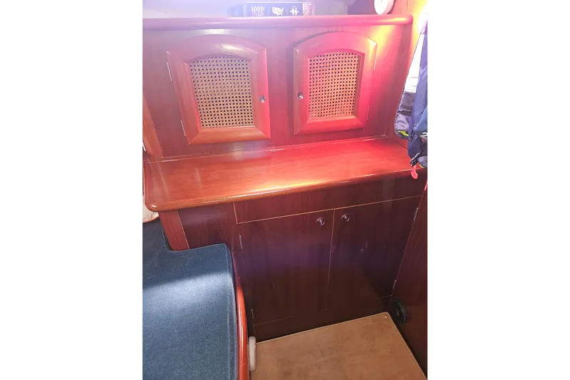 Slide: The Image of Navigation station on 1998 Beneteau Oceanis 381 sailboat with chart, instruments, and seating. - 39