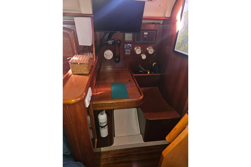 Slide: The Image of 1998 Beneteau 381 sailboat cockpit with steering wheel and seating area. - 55