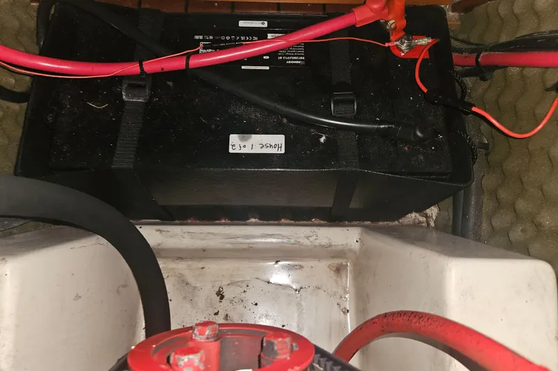 Slide: The Image of Battery compartment of a 1998 Beneteau 381 sailboat with red and black cables. - 71