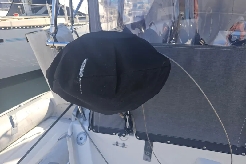 Slide: The Image of Covered steering wheel on a 1998 Beneteau 381 sailboat, docked in a marina. - 72