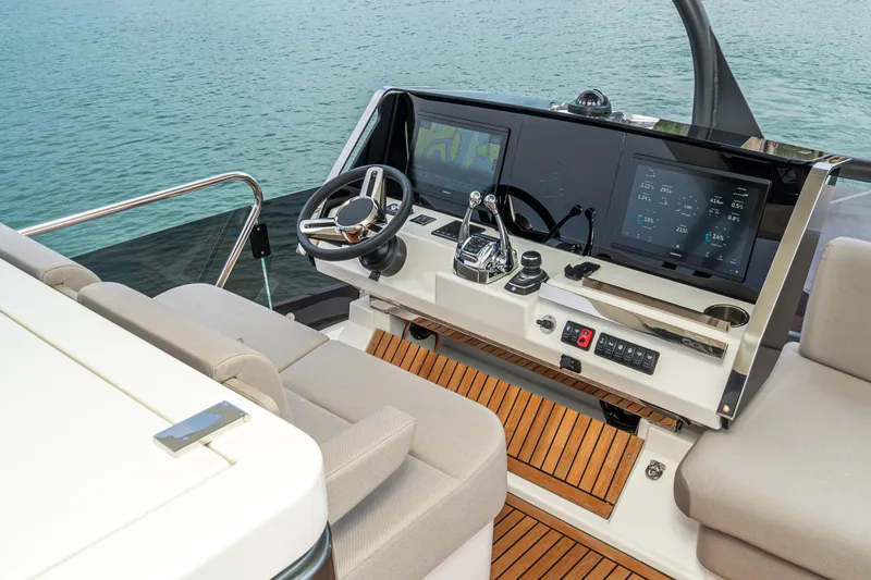 Slide: The Image of Luxurious 2024 Prestige X60 yacht helm with modern controls and dual screens. - 10