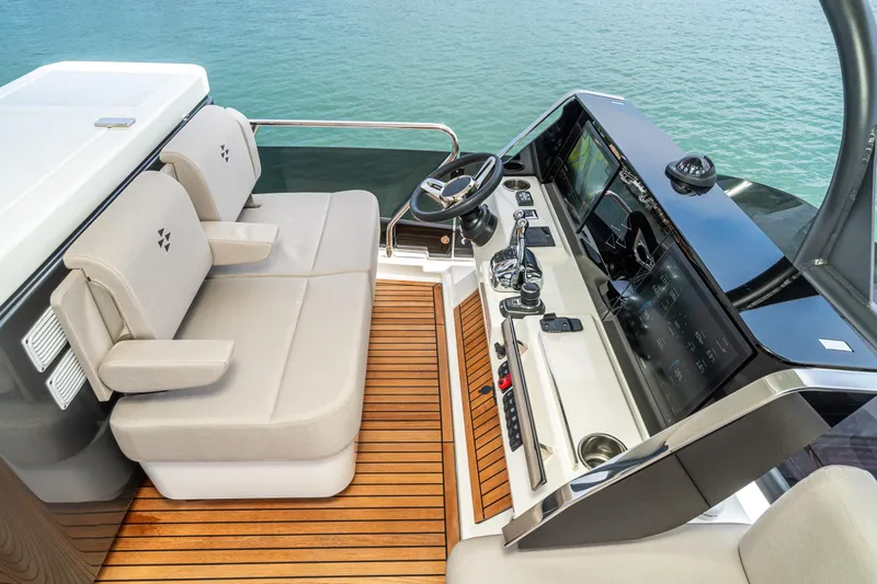 Slide: The Image of Luxurious 2024 Prestige X60 yacht helm with modern controls and comfortable seating. - 11