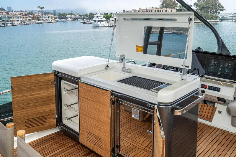 Slide: The Image of Outdoor kitchen on 2024 Prestige X60 yacht with grill and storage, overlooking marina. - 14