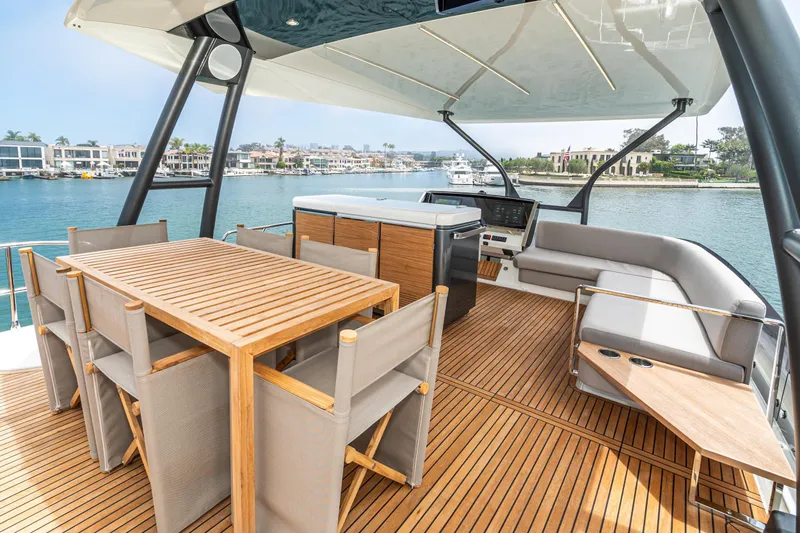 Slide: The Image of Luxurious 2024 Prestige X60 yacht deck with elegant seating and dining area. - 16