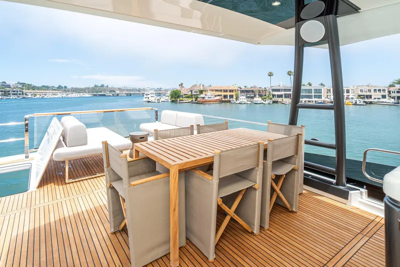 Slide: The Image of Luxurious 2024 Prestige X60 yacht deck with elegant seating and scenic waterfront view. - 17