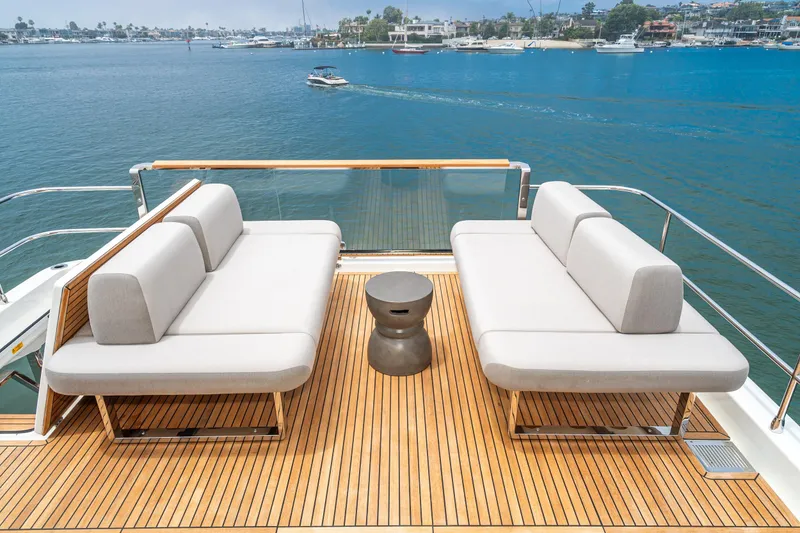 Slide: The Image of Luxurious 2024 Prestige X60 yacht deck with modern seating overlooking serene waters. - 19