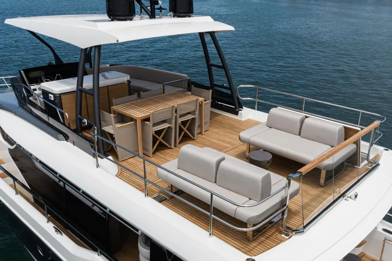 Slide: The Image of Luxurious 2024 Prestige X60 yacht deck with elegant seating and dining area. - 20