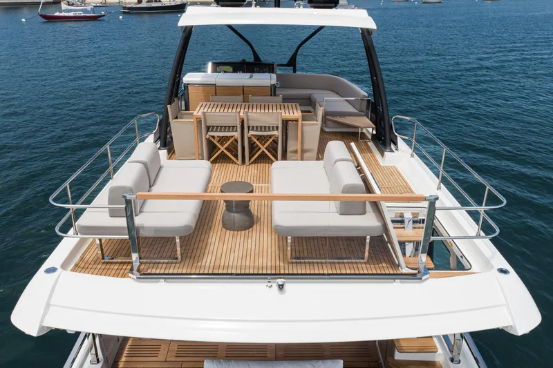 Slide: The Image of Luxurious 2024 Prestige X60 yacht with elegant deck seating and dining area on the water. - 21