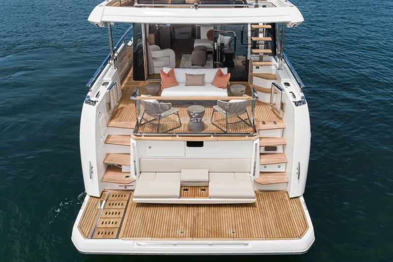 Slide: The Image of Luxurious 2024 Prestige X60 yacht with elegant deck and seating area on the water. - 23
