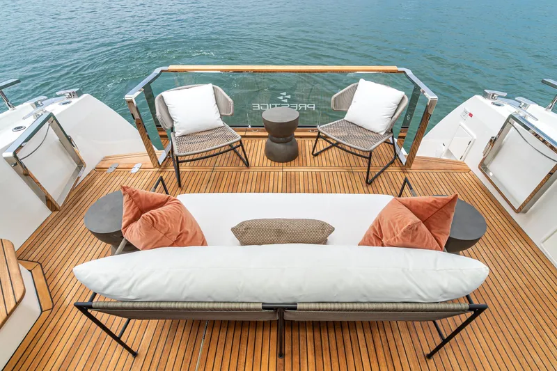 Slide: The Image of Luxurious 2024 Prestige X60 yacht deck with elegant seating and scenic water view. - 27