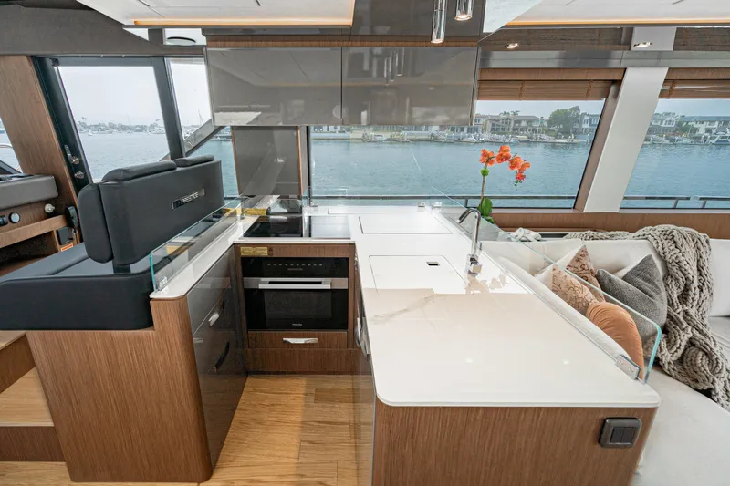 Slide: The Image of Luxurious 2024 Prestige X60 yacht interior with modern kitchen and waterfront view. - 37