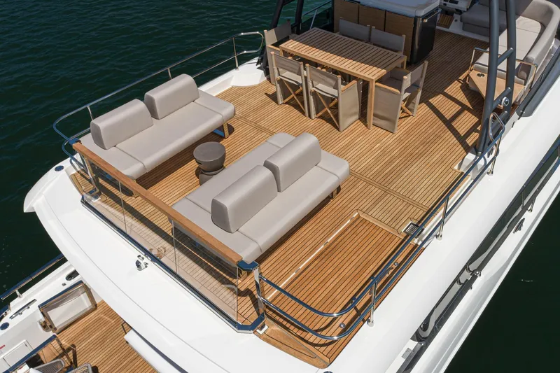 Slide: The Image of Luxurious 2024 Prestige X60 yacht deck with elegant seating and dining area. - 4