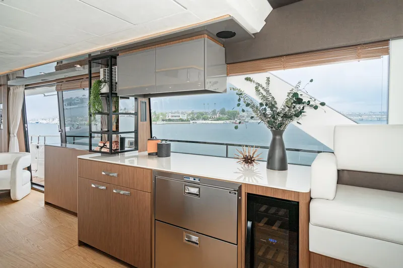 Slide: The Image of Luxurious 2024 Prestige X60 yacht interior with modern kitchen and scenic ocean view. - 40