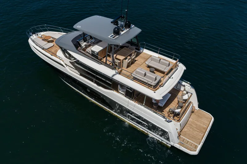 Slide: The Image of 2024 Prestige X60 luxury yacht cruising on open water, showcasing elegant design and spacious decks. - 5