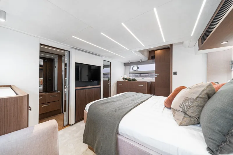 Slide: The Image of Luxurious 2024 Prestige X60 yacht bedroom with modern decor and ambient lighting. - 51