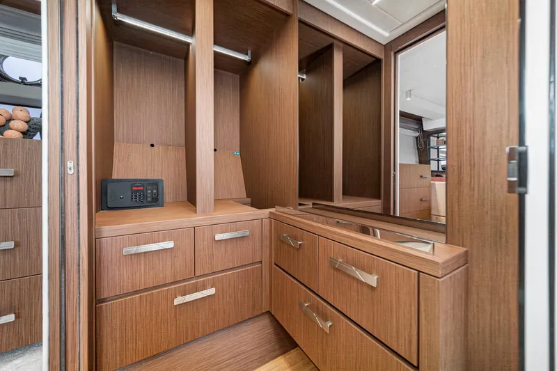 Slide: The Image of Luxurious wooden cabinetry in 2024 Prestige X60 yacht interior, featuring sleek drawers and a safe. - 52
