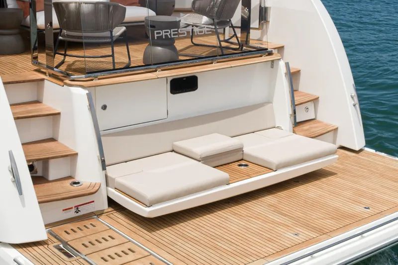 Slide: The Image of 2024 Prestige X60 yacht with elegant teak deck and luxurious seating area. - 57