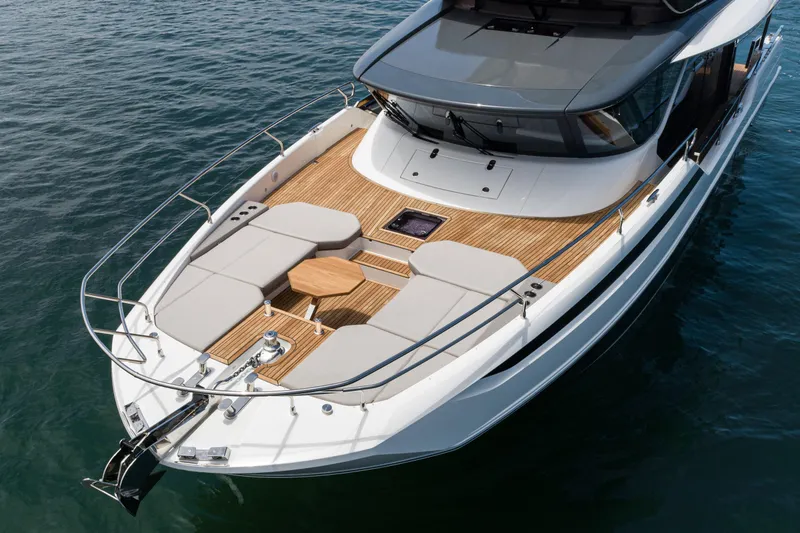 Slide: The Image of Luxurious 2024 Prestige X60 yacht with spacious deck and elegant design on calm waters. - 6