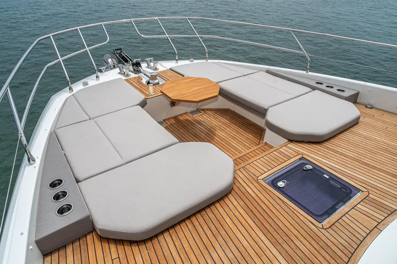 Slide: The Image of Luxurious 2024 Prestige X60 yacht deck with cushioned seating and wooden flooring. - 7