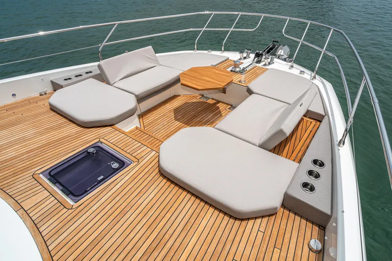 Slide: The Image of Luxurious 2024 Prestige X60 yacht deck with cushioned seating and wooden flooring. - 8
