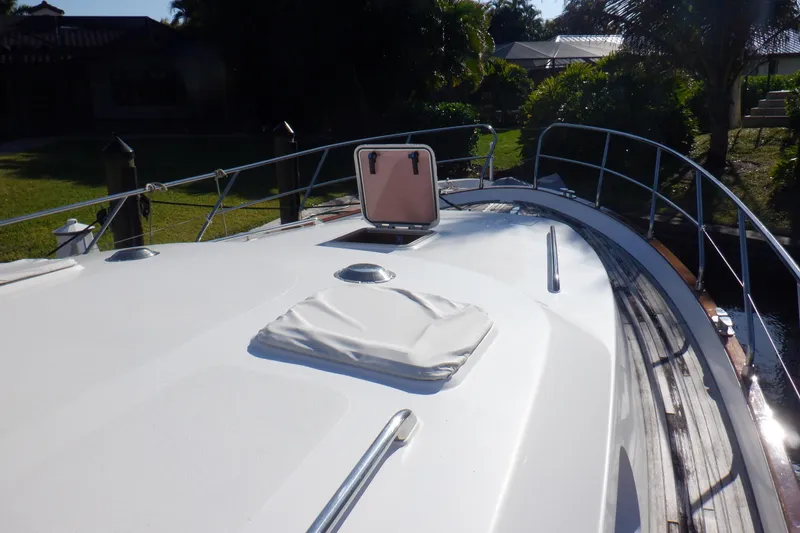 Slide: The Image of 2001 Linssen DS 45 yacht deck with seating, wooden flooring, and waterfront view. - 13