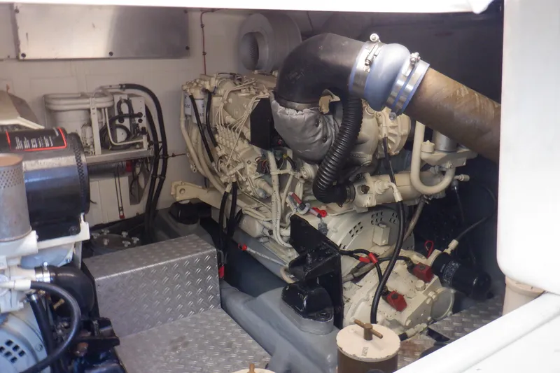 Slide: The Image of Engine room of a 2001 Linssen DS 45 yacht, showcasing mechanical components and piping. - 61