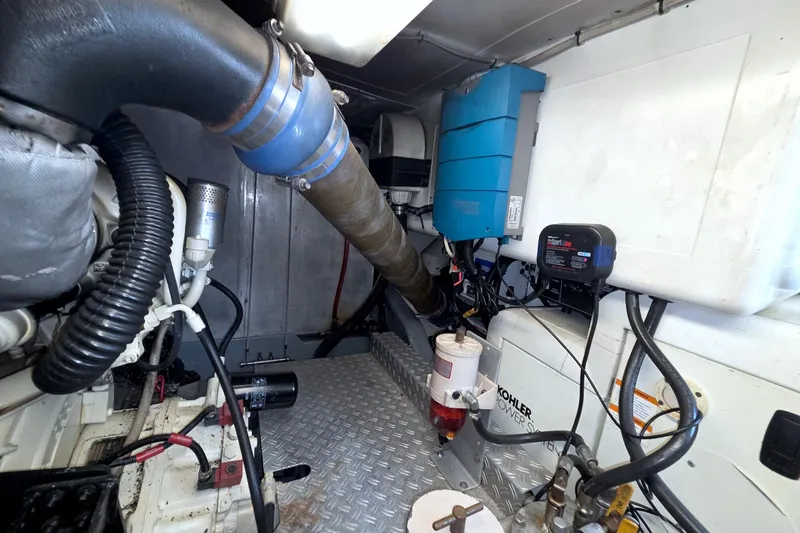 Slide: The Image of Engine room of a 2001 Linssen DS 45 yacht, featuring various mechanical components. - 68