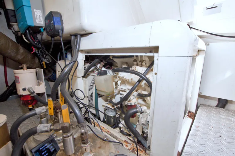 Slide: The Image of Engine room of a 2001 Linssen DS 45 yacht, showcasing mechanical components and wiring. - 70