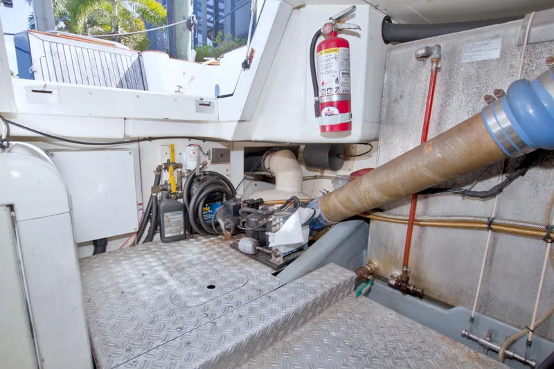 Slide: The Image of Engine room of 2001 Linssen DS 45 yacht with equipment and fire extinguisher. - 73
