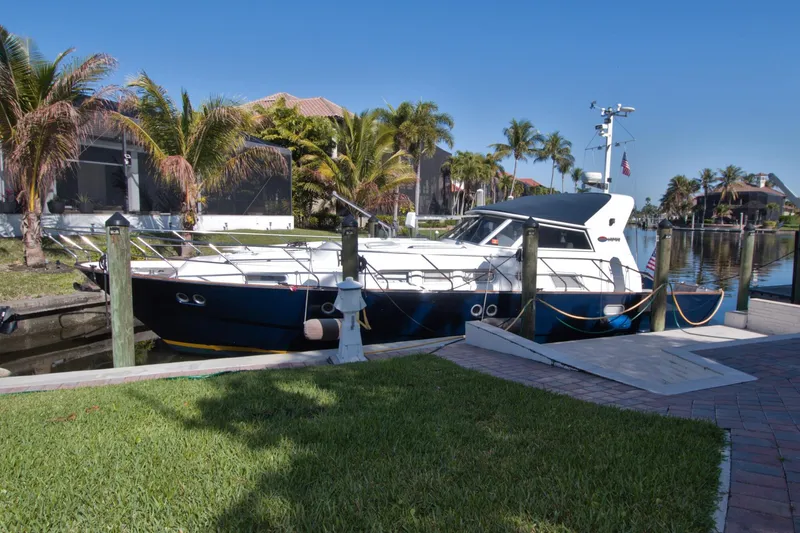 Slide: The Image of 2001 Linssen DS 45 yacht docked by palm trees in a sunny canal setting. - 76