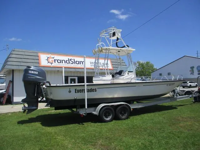 Slide: The Image of 2002 Everglades 250 Center Console boat on trailer outside store. - 11