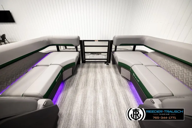 Slide: The Image of 2026 Bennington MOFBSF boat interior with gray seating, purple LED lighting, and Reeder-Trausch Marine logo. - 24