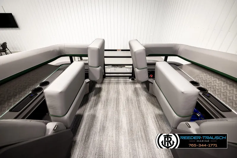 Slide: The Image of 2026 Bennington MOFBSF boat interior with gray seating and cup holders, showcased by Reeder-Trausch Marine. - 25