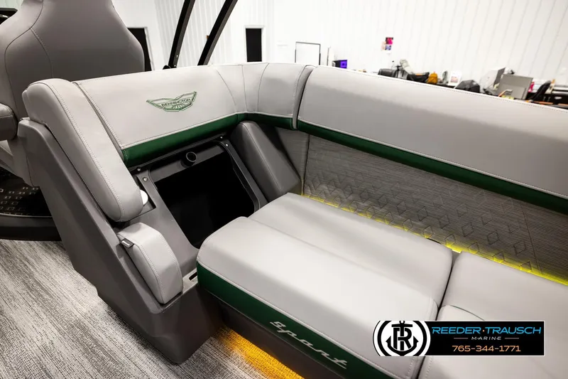 Slide: The Image of 2026 Bennington MOFBSF boat interior with gray and green seating, Reeder-Trausch Marine logo. - 29
