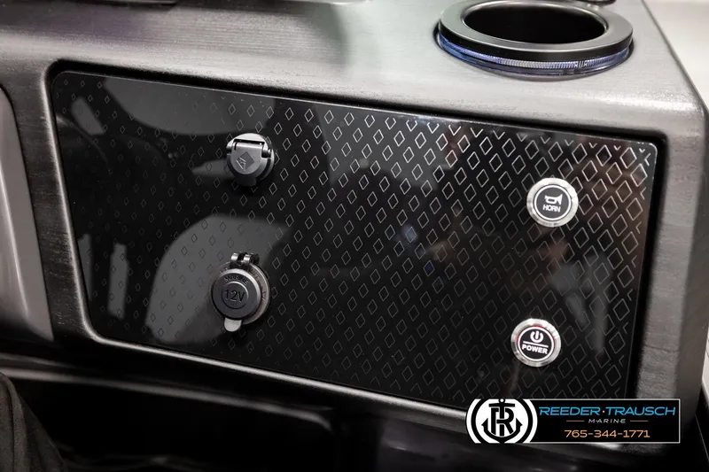 Slide: The Image of 2026 Bennington MOFBSF dashboard with horn, power buttons, and 12V outlet. - 35