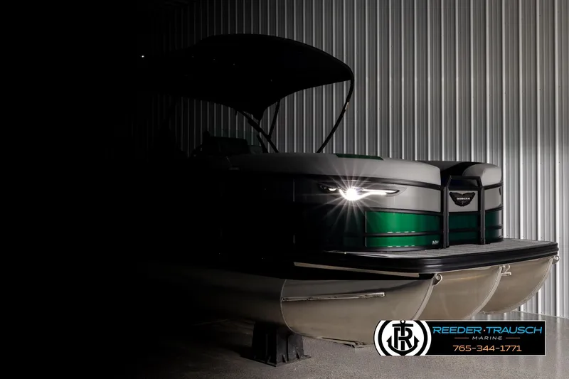 Slide: The Image of 2026 Bennington MOFBSF pontoon boat in dimly lit storage, showcasing sleek design. - 4