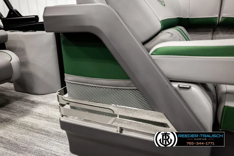 Slide: The Image of 2026 Bennington MOFBSF boat interior with green and gray seating, Reeder-Trausch Marine logo. - 44