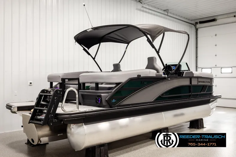 Slide: The Image of 2026 Bennington MOFBSF pontoon boat in showroom with canopy and modern design. - 6