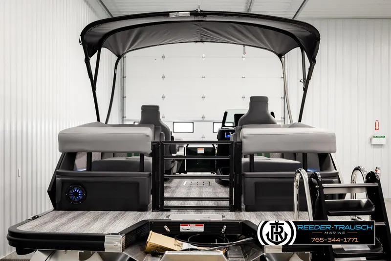 Slide: The Image of 2026 Bennington MOFBSF pontoon boat in a showroom, featuring sleek design and modern seating. - 7