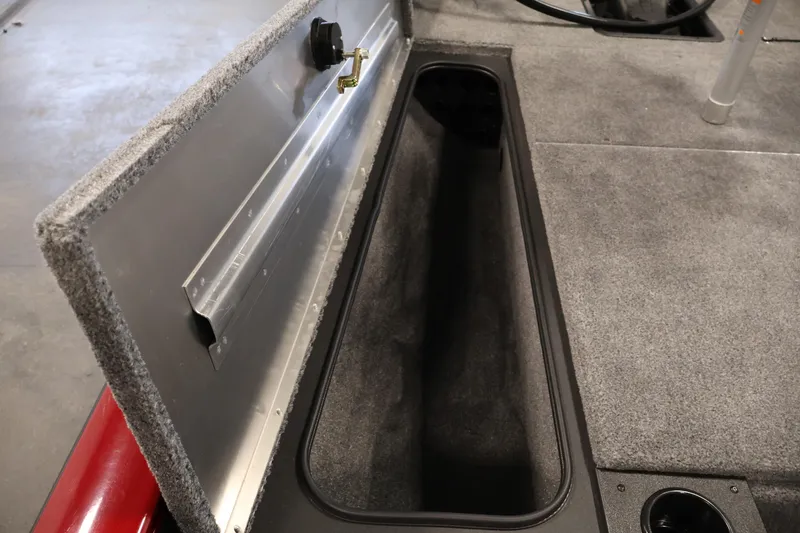 Slide: The Image of 2024 Tracker Pro Team 175 TXW boat storage compartment with carpeted interior and secure latch. - 14