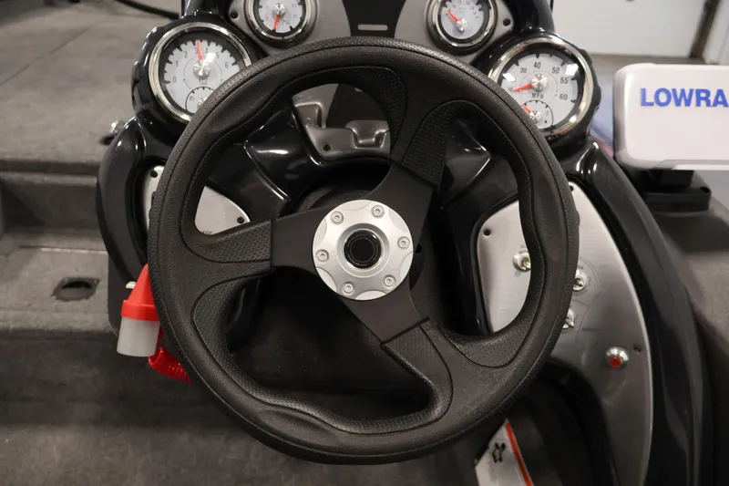 Slide: The Image of 2024 Tracker Pro Team 175 TXW boat dashboard with steering wheel and gauges. - 18